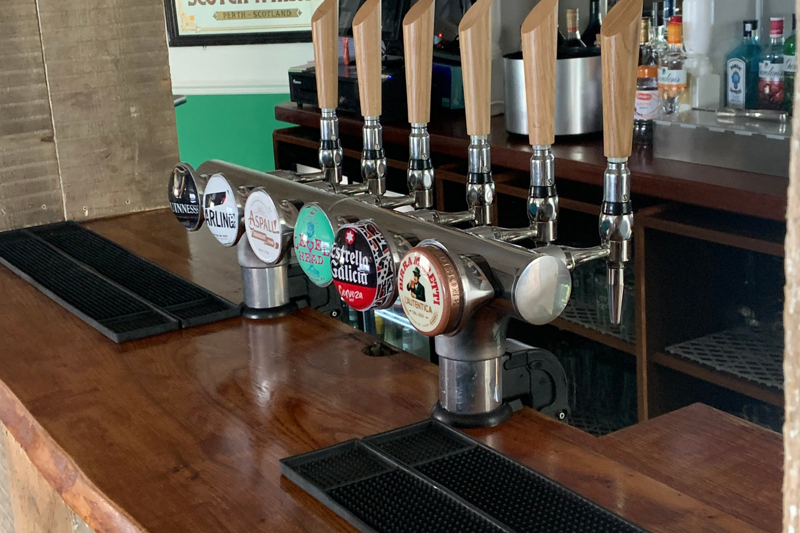 The bar at The Red Cow with a row of polished beer taps